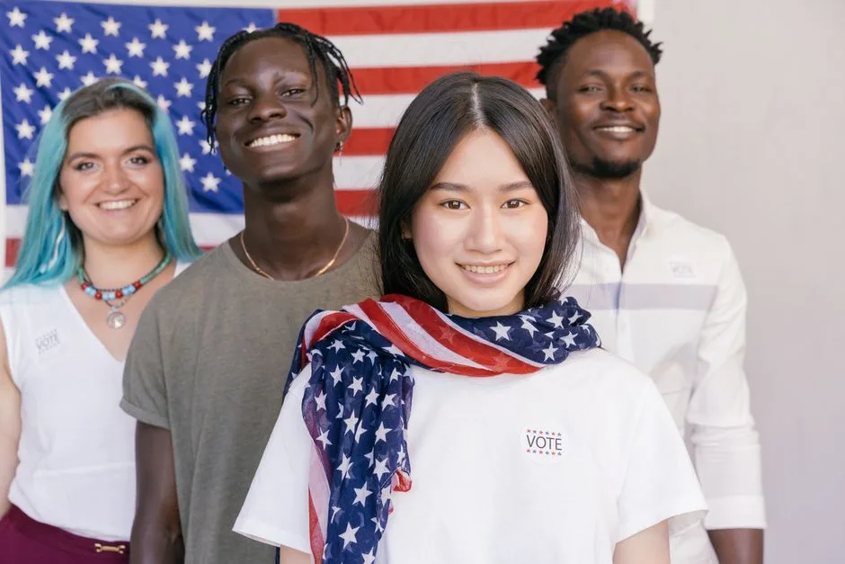 Four diverse individuals with flag, promoting unity and democracy in America.