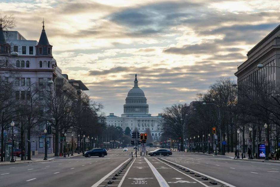 The US Capitol Building captured from a street view in Washington D.C. at sunrise.