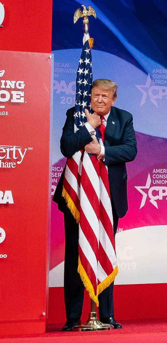 President Donald J. Trump embraces the American flag at CPAC 2019