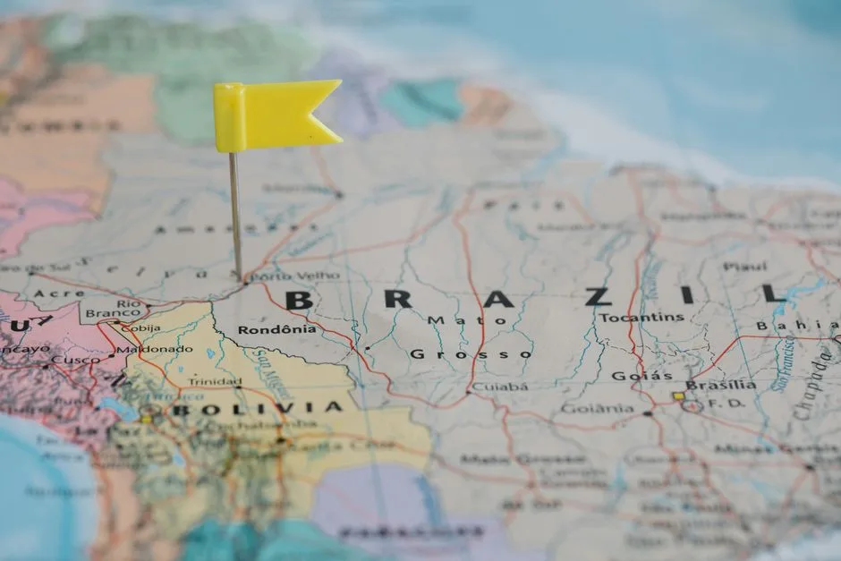 Close-up view of a map with a yellow pin marking a location in Brazil, highlighting the geography.