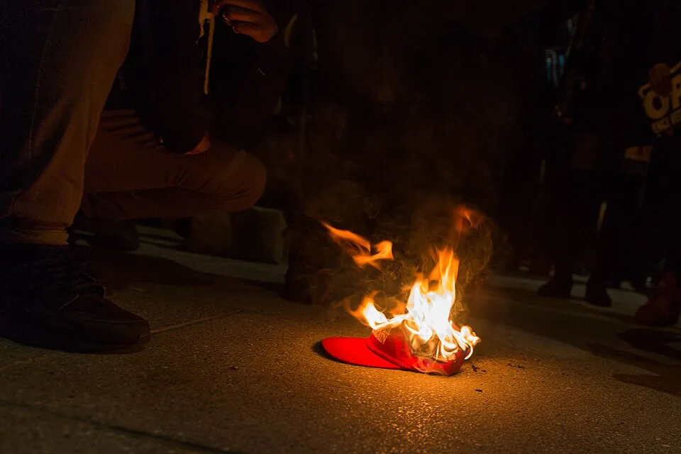 Make America Great Again hat on fire outside The National Press Club (32420564445)
