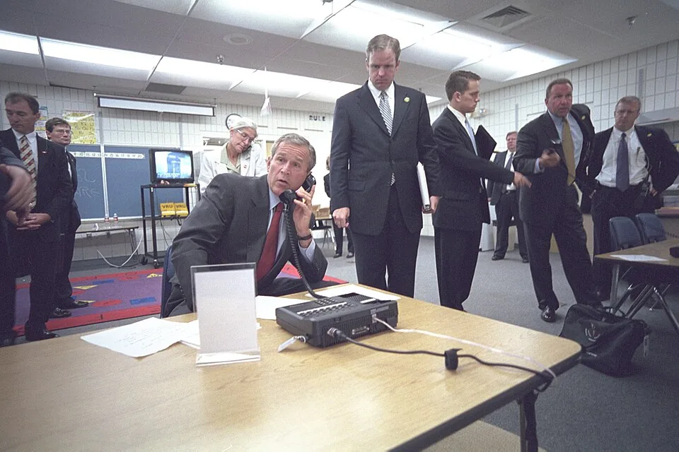 President George W. Bush Talks with Government Officials About the Terrorist Attacks on the World Trade Center on a Secure Phone at Emma E. Booker Elementary School in Sarasota, Florida (P7058-12A)
