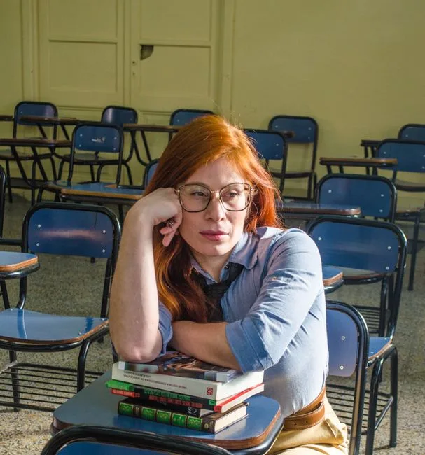 A thoughtful student sitting in an empty classroom in Buenos Aires, Argentina.