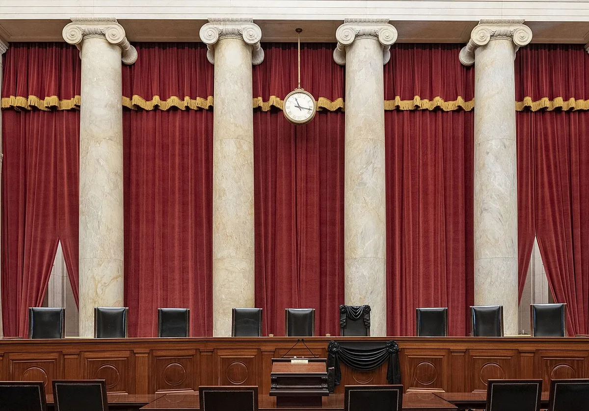 Courtroom of the Supreme Court with Associate Justice Ruth Bader Ginsburg’s chair and the bench in front of her seat draped in black