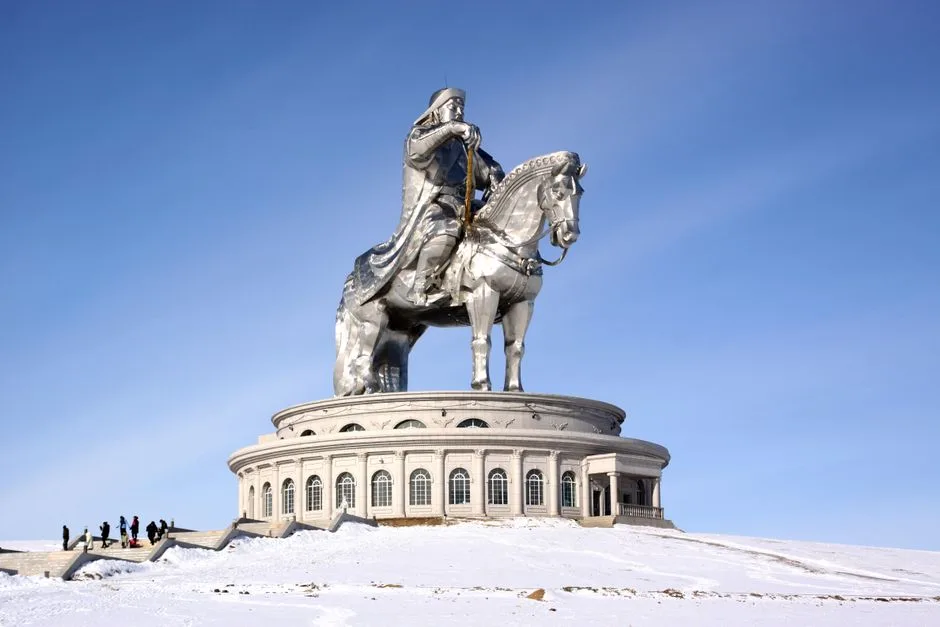 Iconic Genghis Khan statue on horseback in winter, set against a clear blue sky in Mongolia.