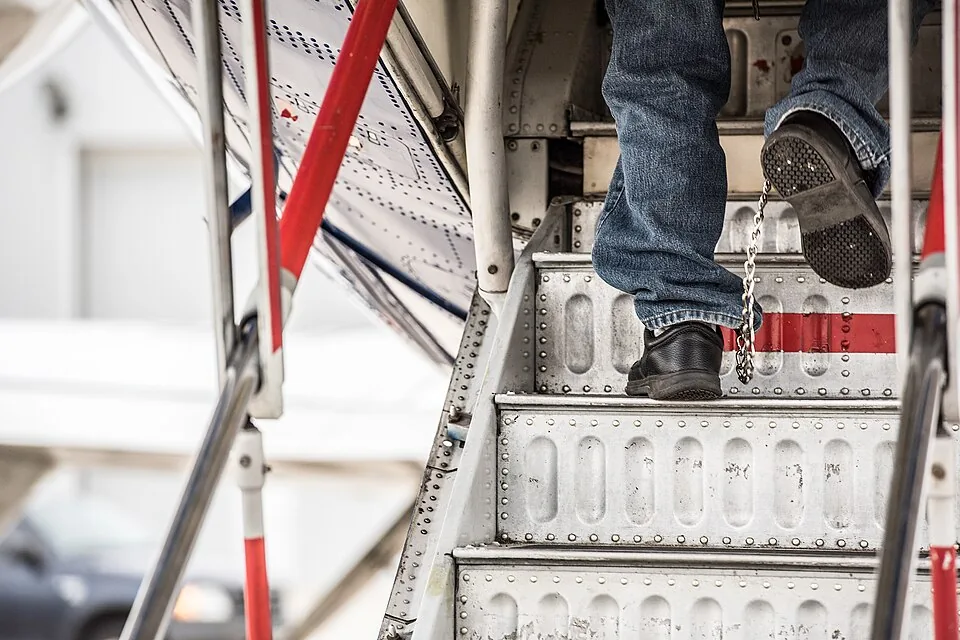 An illegal alien board a plane for a removal flight (50044711751)